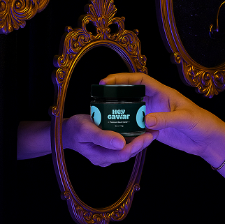 Small Luxuries casual caviar jar reflected in ornate mirror, symbolizing black caviar as everyday luxury